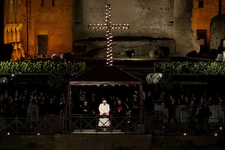 Pope Francis leads the Via Crucis (Way of the Cross) torchlight procession celebrated in front of the Colosseum on Good Friday in Rome, Friday, April 18, 2014. The evening Via Crucis procession at the ancient amphitheater is a Rome tradition that draws a large crowd of faithful, including many of the pilgrims who flock to the Italian capital for Holy Week ceremonies before Easter Sunday. (AP Photo/Andrew Medichini)